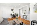 Bright living room features hardwood floors, modern decor, and seamless transition to kitchen at 3740 W Exposition Ave, Denver, CO 80219