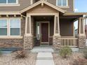 Close-up of the front entrance with stone pillars and house number at 1344 S Coolidge Cir, Aurora, CO 80018