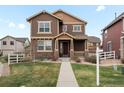 Inviting two-story home with a well-manicured lawn and charming stone accents at 1344 S Coolidge Cir, Aurora, CO 80018
