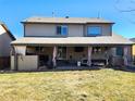 Exterior view of home featuring a covered patio area, well-manicured lawn, and outdoor seating at 11285 Kenton St, Commerce City, CO 80640