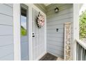 Charming entryway with a decorative wreath and welcome sign, creating a warm and inviting first impression at 15389 E 99Th Way, Commerce City, CO 80022