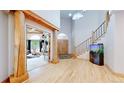 A grand foyer with hardwood floors, high ceilings and a wooden staircase at 974 Spring Ranch Dr, Golden, CO 80401