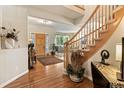 Welcoming foyer featuring a hardwood floor and a staircase leading up at 15962 W 70Th Dr, Arvada, CO 80007