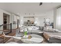 Bright open-concept living room featuring a comfortable couch and modern decor at 14431 Forest St, Thornton, CO 80602