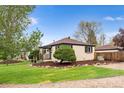 Well-maintained home featuring a lovely yard, rock landscaping, and charming entrance at 3000 N Fillmore St, Denver, CO 80205