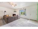 Bright living room features a cozy fireplace and large window with natural light at 18038 Becket Dr, Parker, CO 80134