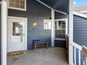 Charming front porch with a welcome bench and blue accent pillow at 11195 Alcott St # D, Westminster, CO 80234