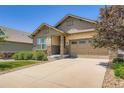 Charming home featuring a two-car garage and stone accents at 7845 S Flat Rock Way, Aurora, CO 80016