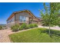 Beautiful home with well-manicured lawn and stone facade at 7845 S Flat Rock Way, Aurora, CO 80016