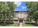 Charming condo building at 350 S Clinton St with manicured front lawn and mature shade trees at 350 S Clinton St # 2A, Denver, CO 80247
