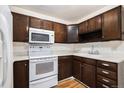 A close up of the kitchen with wooden cabinets and white oven at 350 S Clinton St # 2A, Denver, CO 80247