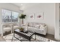 Sun-drenched living room is cozy with contemporary furnishings, and a large window at 15345 W 69Th Dr, Arvada, CO 80007