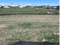An undeveloped lot with views of a well-maintained community green space at 14573 Hudson Way, Thornton, CO 80602
