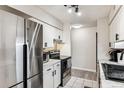 Bright kitchen features stainless steel appliances, white cabinetry, and updated fixtures at 7375 E Quincy Ave # 202, Denver, CO 80237