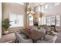 Bright formal dining room with high ceilings, fireplace, and large windows at 9362 S Holland Way, Littleton, CO 80127