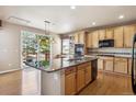 Spacious kitchen features a center island, hardwood floors, and modern appliances at 9362 S Holland Way, Littleton, CO 80127