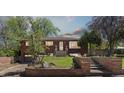 Charming brick home with a well-manicured lawn and inviting front entrance at 1196 S Quebec Way, Denver, CO 80231