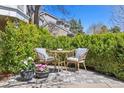 Cozy patio seating area surrounded by lush greenery, perfect for outdoor relaxation at 3 Winged Foot Way, Littleton, CO 80123