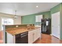 Spacious kitchen with granite countertops, white cabinets, and stainless steel appliances at 9553 Cherry Ln, Thornton, CO 80229