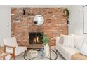 Inviting living room boasting a brick fireplace, modern furniture, and contemporary accents at 155 S Pennsylvania St # 205, Denver, CO 80209