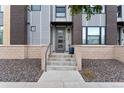 Townhome entrance with modern gray door and stone accents at 1555 Perry St, Denver, CO 80204