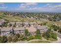 Gorgeous aerial view of a neighborhood with lush landscaping, walking trails, and mountain views at 10994 Shadowbrook Cir, Highlands Ranch, CO 80130