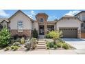 Charming front entrance with stone accents and beautifully landscaped front yard at 10994 Shadowbrook Cir, Highlands Ranch, CO 80130
