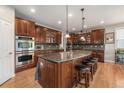 Gourmet kitchen with custom cabinets, granite countertops, and stainless steel appliances at 10994 Shadowbrook Cir, Highlands Ranch, CO 80130