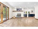 Inviting living room with fireplace, wood mantel, sliding glass doors, and hardwood floors at 205 Loop Dr, Georgetown, CO 80444