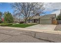 A charming single-Gathering home with a lush green lawn and a two-car garage, situated on a well-maintained street at 6376 S Pierson St, Littleton, CO 80127