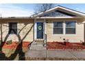 Front entry of the house with landscaping at 6730 Ingalls St, Arvada, CO 80003