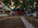 Charming multi-colored single-story home featuring a cozy front porch and vibrant curb appeal at 1256 S Pennsylvania St, Denver, CO 80210