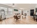 Bright living room with hardwood floors, neutral furniture, and an abundance of natural light at 19431 E Wyoming Ave, Aurora, CO 80017
