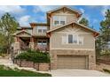 Charming two-story home with stone accents, manicured landscaping, and an attached two-car garage at 20166 E Shady Ridge Rd, Parker, CO 80134