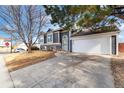 House exterior with driveway and landscaping at 5769 S Nepal Ct, Centennial, CO 80015