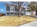 Gray siding house with a 2-car garage and landscaped yard at 5769 S Nepal Ct, Centennial, CO 80015
