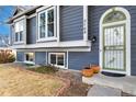 Front entrance with green door and landscaping at 5769 S Nepal Ct, Centennial, CO 80015