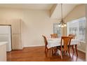 Cozy dining area featuring hardwood floors, large windows, and a classic chandelier at 1120 Opal St # 203, Broomfield, CO 80020