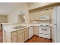 Efficient kitchen with white appliances, ample counter space, and wood cabinets for a functional design at 1120 Opal St # 203, Broomfield, CO 80020
