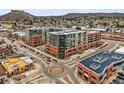Stunning aerial view of a modern apartment building in an urban neighborhood with nearby mountain views at 20 Wilcox St # 517, Castle Rock, CO 80104