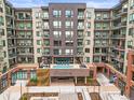 Exterior showcases a modern apartment building with private balconies and outdoor pool at 20 Wilcox St # 517, Castle Rock, CO 80104