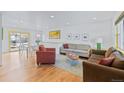 Bright living room with hardwood floors, a cozy seating area, and a dining area with a white table and chairs at 4640 Macky Way, Boulder, CO 80305