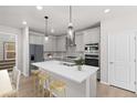 Modern kitchen with a large center island, stainless steel appliances, and sleek gray cabinetry at 7310 Watercress Dr, Littleton, CO 80125