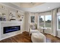 Cozy living room features a modern fireplace, ample natural light, and comfortable seating at 19185 Breton Pl, Monument, CO 80132