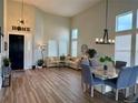 Bright living room with high ceilings, lots of windows, dining area and stylish chandelier at 653 Glenarbor Cir, Longmont, CO 80504