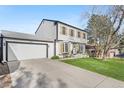 Attractive two-story home with a lush green lawn and a spacious two-car garage at 4733 S Vivian Ct, Morrison, CO 80465