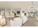 Elegant living room featuring a contemporary decor style and white furnishings, adjacent to the dining area at 800 N Washington St # 1010, Denver, CO 80203