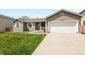 Inviting exterior of home with well-manicured lawn and attached two-car garage at 20709 E Hampden Pl, Aurora, CO 80013