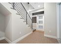 Bright entryway with modern staircase, white walls, and a door with frosted glass panels at 4469 Tennyson St # 4, Denver, CO 80212