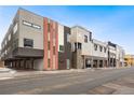 Contemporary apartment complex featuring multi-tone exterior, attached garages, and street parking spaces at 4469 Tennyson St # 4, Denver, CO 80212